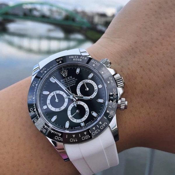 White rubber strap with black-white Rolex watch on wrist