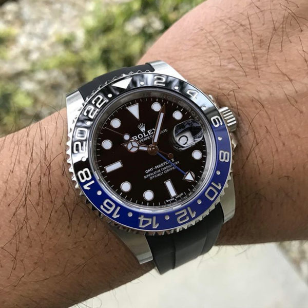 Black rubber strap with Rolex GMT Master on wrist